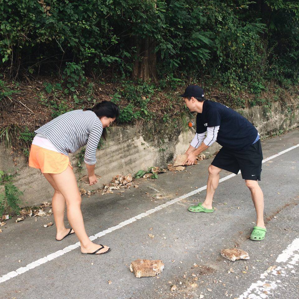  Rona and John moving rocks off to the side of the road in case of an accident! 